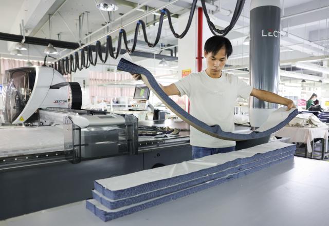(260908) -- YUDU, Sept. 8, 2026 (Xinhua) -- A worker works at a workshop of a fashion company in Yudu County, east China's Jiangxi Province, Sept. 3, 2026. Yudu, one of the starting points of the Central Red Army's Long March, the epic 1934-1936 trek that broke through Kuomintang siege, has in recent years  focused on developing the textile and garment industry, forming a complete industrial chain from spinning, weaving, printing, garment manufacturing and e-commerce sales. The revenue of the industry here exceeded 100 billion yuan (about 14.9 billion U.S. dollars) in 2025, creating nearly 200,000 jobs. (Xinhua/Wang Jingqiang)