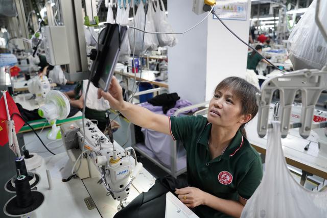 (260908) -- YUDU, Sept. 8, 2026 (Xinhua) -- A worker works on a production line of a fashion company in Yudu County, east China's Jiangxi Province, Sept. 3, 2026. Yudu, one of the starting points of the Central Red Army's Long March, the epic 1934-1936 trek that broke through Kuomintang siege, has in recent years  focused on developing the textile and garment industry, forming a complete industrial chain from spinning, weaving, printing, garment manufacturing and e-commerce sales. The revenue of the industry here exceeded 100 billion yuan (about 14.9 billion U.S. dollars) in 2025, creating nearly 200,000 jobs. (Xinhua/Zhou Mi)