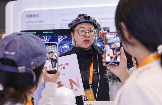 (260908) -- BEIJING, Sept. 8, 2026 (Xinhua) -- Journalists learn about a first-person data collection device during a media preview event of the 2026 China International Fair for Trade in Services (CIFTIS) in Beijing, capital of China, Sept. 8, 2026. The 2026 CIFTIS held a media preview event here on Tuesday. This year's CIFTIS, set to be held from Sept. 9 to 13 in Beijing, will bring together exhibitors from over 90 countries and international organizations, along with more than 1,800 companies. (Xinhua/Zhang Yuwei)
