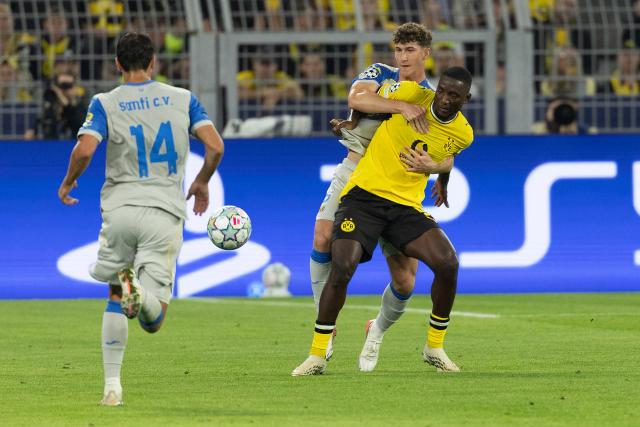 (260909) -- DORTMUND, Sept. 9, 2026 (Xinhua) -- Serhou Guirassy (R) of Borussia Dortmund vies with Pau Navarro (C) of Villarreal during the UEFA Champions League football match between Borussia Dortmund and Villarreal in Dortmund, Germany, Sept. 8, 2026. (Photo by Joachim Bywaletz/Xinhua)