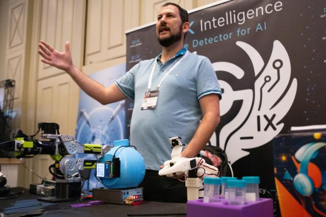 (260909) -- TEL AVIV, Sept. 9, 2026 (Xinhua) -- A participant introduces a robotic hand designed for the medical field at Israel's First National Physical AI Conference in Tel Aviv, Israel, Sept. 8, 2026. Israel's first National Physical AI Conference, hosted by Israel's National AI Directorate, was held here on Tuesday, showcasing physical AI applications across industry, medicine, entertainment, infrastructure, and defense under the theme "Artificial Intelligence Moving from the Screen to the Physical World." (Xinhua/Chen Junqing)