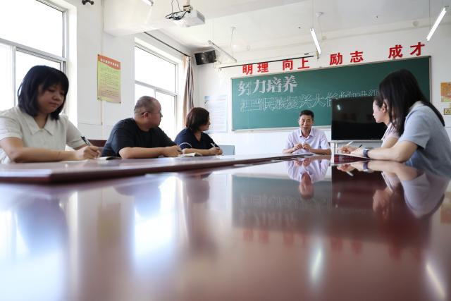 (260909) -- TIANJIN, Sept. 9, 2026 (Xinhua) -- Zheng Baoguo (C) has a meeting with colleagues at a school office in Luozhuangzi Town of Jizhou District in Tianjin, north China, on Sept. 3, 2026.
  The Sangyuan campus of Hongshuizhuang Central Primary School is located at the foot of the Yanshan Mountains in Jizhou District. The small rural school has just 28 students and serves three neighboring villages. It allows local children to attend classes close to home rather than travel nearly 10 kilometers to the town's central primary school.
  Zheng Baoguo, 56 and a native of Jizhou District, has worked at the school for more than 20 years. After graduating from a secondary normal school in 1989, he became a rural teacher. He has long believed that education is a key to a brighter future for children in mountainous areas.
  In 2003, Zheng became the first principal of the Sangyuan campus. Although he later had an opportunity to work in an urban school, he chose to stay and continue his career in his hometown. More than two decades later, Zheng still teaches classes himself despite serving as principal, and he always creates a relaxed and cheerful atmosphere for his students.
  "A teacher can change a child's life. As a teacher, I must live up to families' trust," Zheng said, "As long as the school remains open, I will keep doing my best to ensure that children in these mountain villages have access to education close to home." (Xinhua/Li Ran)