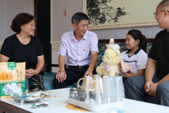(260909) -- TIANJIN, Sept. 9, 2026 (Xinhua) -- Zheng Baoguo (2nd L) pays a home visit to a student in Luozhuangzi Town of Jizhou District in Tianjin, north China, on Sept. 3, 2026.
  The Sangyuan campus of Hongshuizhuang Central Primary School is located at the foot of the Yanshan Mountains in Jizhou District. The small rural school has just 28 students and serves three neighboring villages. It allows local children to attend classes close to home rather than travel nearly 10 kilometers to the town's central primary school.
  Zheng Baoguo, 56 and a native of Jizhou District, has worked at the school for more than 20 years. After graduating from a secondary normal school in 1989, he became a rural teacher. He has long believed that education is a key to a brighter future for children in mountainous areas.
  In 2003, Zheng became the first principal of the Sangyuan campus. Although he later had an opportunity to work in an urban school, he chose to stay and continue his career in his hometown. More than two decades later, Zheng still teaches classes himself despite serving as principal, and he always creates a relaxed and cheerful atmosphere for his students.
  "A teacher can change a child's life. As a teacher, I must live up to families' trust," Zheng said, "As long as the school remains open, I will keep doing my best to ensure that children in these mountain villages have access to education close to home." (Xinhua/Li Ran)