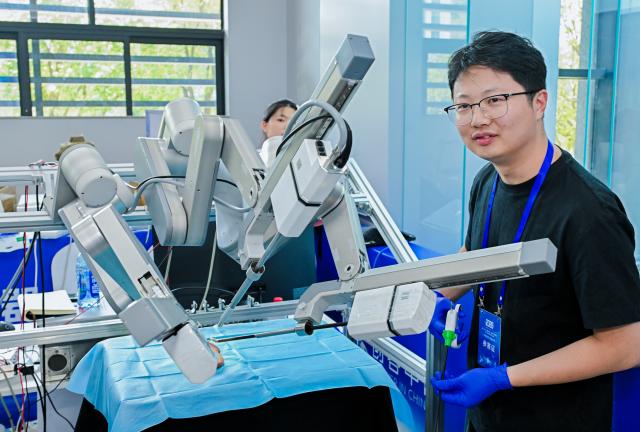 (260909) -- CHONGQING, Sept. 9, 2026 (Xinhua) -- This photo taken on Sept. 9, 2026 shows robot surgical operation competition during the final of the 11th "Maker in China" intelligent bionic robot innovation and entrepreneurship competition for small and medium-sized enterprises in Chongqing, southwest China. The final of the event kicked off in Chongqing on Wednesday, with the participation of some 100 teams from all over the country. This competition will last until Sept. 11. (Xinhua)