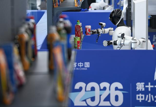 (260909) -- CHONGQING, Sept. 9, 2026 (Xinhua) -- A robot fetches goods from the shelf during the final of the 11th "Maker in China" intelligent bionic robot innovation and entrepreneurship competition for small and medium-sized enterprises in Chongqing, southwest China, Sept. 9, 2026. The final of the event kicked off in Chongqing on Wednesday, with the participation of some 100 teams from all over the country. This competition will last until Sept. 11. (Xinhua/Chen Cheng)