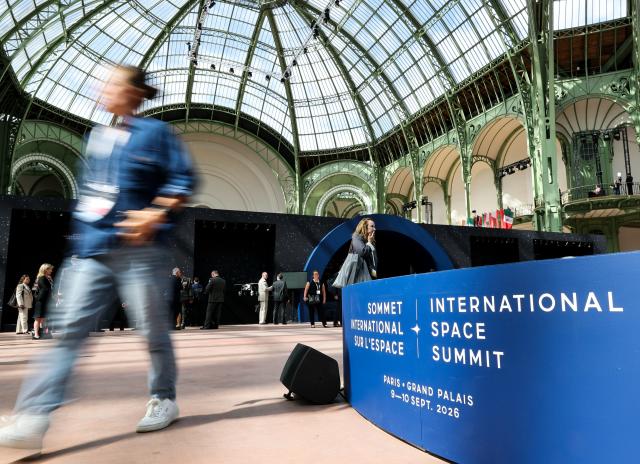 (260909) -- PARIS, Sept. 9, 2026 (Xinhua) -- A visitor passes the logo of the International Space Summit at the Grand Palais in Paris, France, Sept. 9, 2026. The first International Space Summit opened Wednesday in Paris, bringing together heads of state and government, scientists, astronauts and industry representatives. (Xinhua/Wu Huiwo)