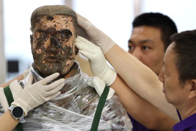 (260909) -- XI'AN, Sept. 9, 2026 (Xinhua) -- Restoration specialists piece together a terracotta warrior at the on-site conservation lab of the Pit No.1 of the Emperor Qinshihuang's Mausoleum Site Museum in Xi'an, northwest China's Shaanxi Province, Sept. 3, 2026.
  At the world-famous Terracotta Warriors site in Xi'an, visitors can now witness a once behind-the-scenes process -- experts meticulously restoring over 2,000-year-old clay soldiers. At the newly launched conservation lab in Pit No. 1, specialists piece fragmented pottery together manually, reviving scattered relics into solemn and life-size warriors.
  The lab officially opened in 2024, celebrating the 50th anniversary of the discovery and excavation of the iconic Terracotta Warriors. A professional excavation and preservation facility in Pit No. 2 was also completed and put into operation. The two facilities form a full-cycle conservation system covering excavation, transportation, restoration and storage. 
  This advanced system greatly improves the protection of the warriors' original pigments. Buried underground for over 2,000 years, the Terracotta Warriors suffered severe damage from fires, soil collapses and underground water fluctuations, with most original colors fading away over time. Previously, surviving paint layer would easily curl, peel or flake off once exposed to drastic environmental changes after excavation. Today, newly unearthed painted relics are directly transferred to the on-site lab. Through keeping stable humidity control, ultrasonic inspection, 3D scanning, professional cleaning and reinforcement treatment, researchers now do their utmost to preserve the warriors' ancient original hues. (Xinhua/Li Yibo)
