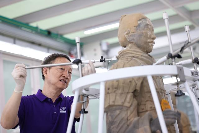 (260909) -- XI'AN, Sept. 9, 2026 (Xinhua) -- A restoration specialist debugs sensors for terracotta warrior restoration at the on-site conservation lab of the Pit No.1 of the Emperor Qinshihuang's Mausoleum Site Museum in Xi'an, northwest China's Shaanxi Province, Sept. 3, 2026.
  At the world-famous Terracotta Warriors site in Xi'an, visitors can now witness a once behind-the-scenes process -- experts meticulously restoring over 2,000-year-old clay soldiers. At the newly launched conservation lab in Pit No. 1, specialists piece fragmented pottery together manually, reviving scattered relics into solemn and life-size warriors.
  The lab officially opened in 2024, celebrating the 50th anniversary of the discovery and excavation of the iconic Terracotta Warriors. A professional excavation and preservation facility in Pit No. 2 was also completed and put into operation. The two facilities form a full-cycle conservation system covering excavation, transportation, restoration and storage. 
  This advanced system greatly improves the protection of the warriors' original pigments. Buried underground for over 2,000 years, the Terracotta Warriors suffered severe damage from fires, soil collapses and underground water fluctuations, with most original colors fading away over time. Previously, surviving paint layer would easily curl, peel or flake off once exposed to drastic environmental changes after excavation. Today, newly unearthed painted relics are directly transferred to the on-site lab. Through keeping stable humidity control, ultrasonic inspection, 3D scanning, professional cleaning and reinforcement treatment, researchers now do their utmost to preserve the warriors' ancient original hues. (Xinhua/Li Yibo)