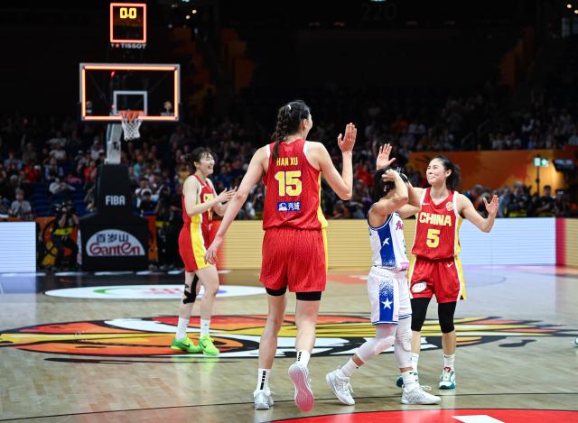 (260910) -- BERLIN, Sept. 10, 2026 (Xinhua) -- Han Xu (2nd L) and Wang Siyu (1st R) of China celebrate victory after the qualification to quarter-finals match between China and Puerto Rico at the FIBA Women's Basketball World Cup 2026 in Berlin, Germany, Sept. 9, 2026. (Xinhua/Zhang Haofu)