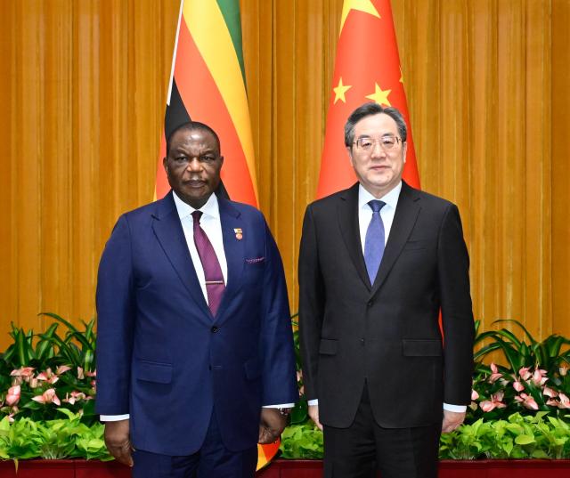 (260910) -- BEIJING, Sept. 10, 2026 (Xinhua) -- Chinese Vice Premier Ding Xuexiang, also a member of the Standing Committee of the Political Bureau of the Communist Party of China Central Committee, meets with Zimbabwean Vice President Constantino Chiwenga in Beijing, capital of China, Sept. 9, 2026. (Xinhua/Shen Hong)