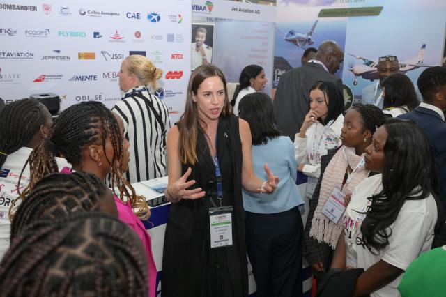 (260910) -- NAIROBI, Sept. 10, 2026 (Xinhua) -- An exhibitor explains airline operations to students at the 10th Aviation Africa Summit and Exhibition in Nairobi, Kenya, Sept. 9, 2026. The 10th Aviation Africa Summit and Exhibition, held Wednesday and Thursday in Nairobi, the Kenyan capital, brought together about 2,500 delegates from more than 100 countries, including representatives from 135 airlines and aviation operators. (Xinhua/Yang Guang)