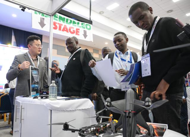 (260910) -- NAIROBI, Sept. 10, 2026 (Xinhua) -- Visitors learn about products from a Chinese drone company at the 10th Aviation Africa Summit and Exhibition in Nairobi, Kenya, Sept. 9, 2026. The 10th Aviation Africa Summit and Exhibition, held Wednesday and Thursday in Nairobi, the Kenyan capital, brought together about 2,500 delegates from more than 100 countries, including representatives from 135 airlines and aviation operators. (Xinhua/Yang Guang)