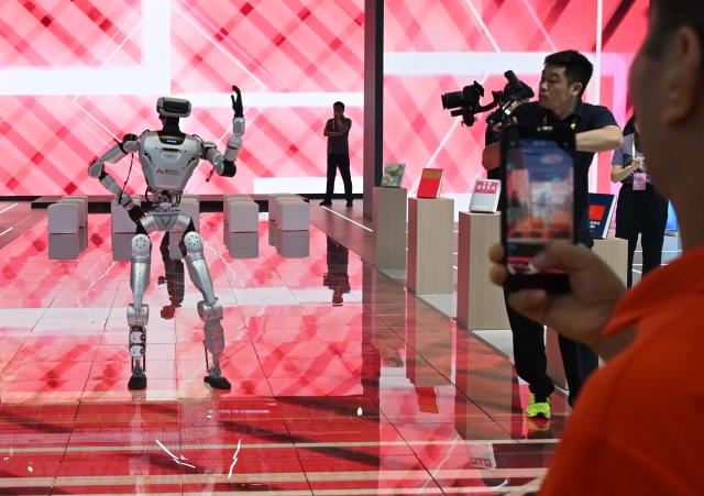 (260910) -- XIAMEN, Sept. 10, 2026 (Xinhua) -- People watch a robot performing at the 26th China International Fair for Investment and Trade in Xiamen, southeast China's Fujian Province, Sept. 9, 2026. The 26th China International Fair for Investment and Trade opened Tuesday in Xiamen, drawing registrations from more than 1,200 government institutions and business delegations from 129 countries and regions, as well as 30 international organizations. Technological achievements in cutting-edge fields including artificial intelligence, low-altitude economy, new energy storage, and green power are showcased in this event. (Xinhua/Lin Shanchuan)