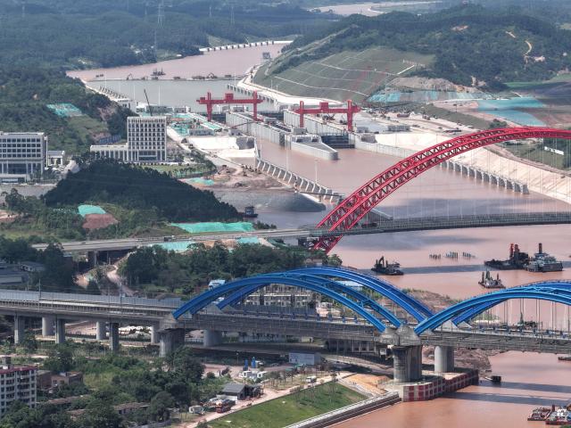 (260910) -- NANNING, Sept. 10, 2026 (Xinhua) -- An aerial drone photo taken on June 2, 2026 shows the Qingnian Hub along the Pinglu Canal and bridges at the lower reaches of the canal in Qinzhou City, south China's Guangxi Zhuang Autonomous Region. Pinglu Canal in south China's Guangxi Zhuang Autonomous Region will become operational on Sept. 16. The 134.2-km canal links the Xijiang River shipping route in the north with the Beibu Gulf in the south. It is China's first major river-to-sea canal project that has been planned and coordinated at the national level since 1949.
   Centering the Pinglu Canal Economic Belt as its main artery, Guangxi focuses on large-capacity, port and waterway-related industries. It builds port-adjacent parks along the canal tailored to local conditions, forming industrial clusters that support upstream and downstream industries and foster collaboration among large, medium, and small enterprises.
   Across Guangxi, localities leverage their own resources to position themselves within a maritime-oriented industrial layout, advancing the high-quality development of the marine economy. (Xinhua/Zhou Hua)