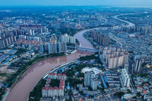 (260910) -- NANNING, Sept. 10, 2026 (Xinhua) -- An aerial drone photo taken on Aug. 19, 2026 shows the city view and the Pinglu Canal in Qinzhou City, south China's Guangxi Zhuang Autonomous Region. Pinglu Canal in south China's Guangxi Zhuang Autonomous Region will become operational on Sept. 16. The 134.2-km canal links the Xijiang River shipping route in the north with the Beibu Gulf in the south. It is China's first major river-to-sea canal project that has been planned and coordinated at the national level since 1949.
   Centering the Pinglu Canal Economic Belt as its main artery, Guangxi focuses on large-capacity, port and waterway-related industries. It builds port-adjacent parks along the canal tailored to local conditions, forming industrial clusters that support upstream and downstream industries and foster collaboration among large, medium, and small enterprises.
   Across Guangxi, localities leverage their own resources to position themselves within a maritime-oriented industrial layout, advancing the high-quality development of the marine economy. (Xinhua/Cao Yiming)