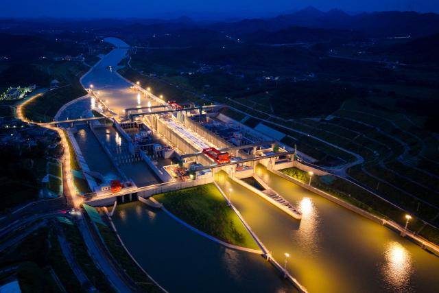 (260910) -- NANNING, Sept. 10, 2026 (Xinhua) -- An aerial drone photo taken on Aug. 18, 2026 shows the Madao Hub along the Pinglu Canal in Qinzhou City, south China's Guangxi Zhuang Autonomous Region. Pinglu Canal in south China's Guangxi Zhuang Autonomous Region will become operational on Sept. 16. The 134.2-km canal links the Xijiang River shipping route in the north with the Beibu Gulf in the south. It is China's first major river-to-sea canal project that has been planned and coordinated at the national level since 1949.
   Centering the Pinglu Canal Economic Belt as its main artery, Guangxi focuses on large-capacity, port and waterway-related industries. It builds port-adjacent parks along the canal tailored to local conditions, forming industrial clusters that support upstream and downstream industries and foster collaboration among large, medium, and small enterprises.
   Across Guangxi, localities leverage their own resources to position themselves within a maritime-oriented industrial layout, advancing the high-quality development of the marine economy. (Xinhua/Wang Liang)