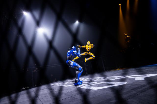 (260910) -- RIYADH, Sept. 10, 2026 (Xinhua) -- A yellow humanoid robot launches an airborne attack against its blue opponent during the CyberHero x Riyadh, a humanoid robot combat event, in Riyadh, Saudi Arabia, Sept. 9, 2026. (Hero Esports/Handout via Xinhua)