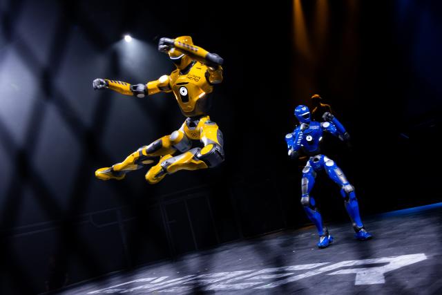 (260910) -- RIYADH, Sept. 10, 2026 (Xinhua) -- A yellow humanoid robot launches an airborne attack during the CyberHero x Riyadh, a humanoid robot combat event, in Riyadh, Saudi Arabia, Sept. 9, 2026. (Hero Esports/Handout via Xinhua)