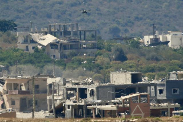 (260910) -- MANSOURI, Sept. 10, 2026 (Xinhua) -- This photo taken on Sept. 9, 2026 shows an Israeli drone dropping explosives over houses in the town of Mansouri, southern Lebanon. (Photo by Ali Hashisho/Xinhua)