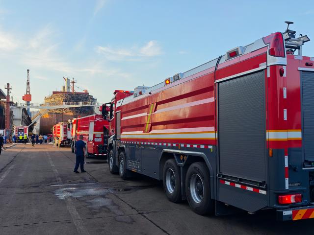 (260910) -- QINGDAO, Sept. 10, 2026 (Xinhua) -- Rescuers operate at the site of a cargo ship fire in Qingdao, east China's Shandong Province, Sept. 10, 2026. Twenty people were confirmed dead and five others remained missing after a foreign cargo ship caught fire during maintenance at a shipyard here on Thursday, local authorities said. (Xinhua/Li Aoqiu)