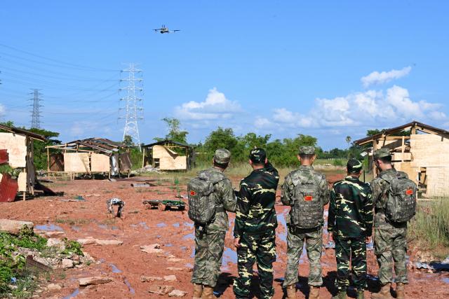 (260910) -- VIENTIANE, Sept. 10, 2026 (Xinhua) -- Participating team members deploy unmanned equipment during the mixed-unit joint training phase of the China-Laos "Peace Train-2026" joint humanitarian medical rescue exercise in Vientiane, Laos, Sept. 9, 2026. TO GO WITH "China, Laos use drones, robot dogs in 'Peace Train-2026' medical exercise" (Photo by Zeng Li/Xinhua)