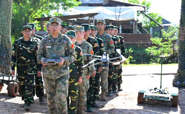 (260910) -- VIENTIANE, Sept. 10, 2026 (Xinhua) -- Participating team members deploy unmanned rescue systems during the mixed-unit joint training phase of the China-Laos "Peace Train-2026" joint humanitarian medical rescue exercise in Vientiane, Laos, Sept. 9, 2026. TO GO WITH "China, Laos use drones, robot dogs in 'Peace Train-2026' medical exercise" (Photo by Zeng Li/Xinhua)