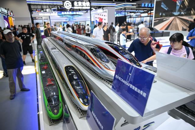 (260912) -- BEIJING, Sept. 12, 2026 (Xinhua) -- Visitors view train models at the 2026 China International Fair for Trade in Services (CIFTIS) at Shougang Park in Beijing, capital of China, Sept. 12, 2026. The 2026 CIFTIS opens to the general public from Sept. 12 to 13. Visitors with reservation can access the fair free of charge. (Xinhua/Zheng Huansong)