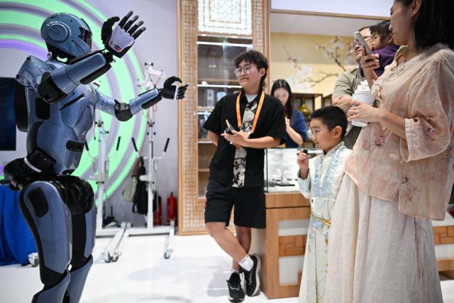 (260912) -- BEIJING, Sept. 12, 2026 (Xinhua) -- Visitors interact with a humanoid robot at the themed exhibition area for culture and tourism services during the 2026 China International Fair for Trade in Services (CIFTIS) at Shougang Park in Beijing, capital of China, Sept. 12, 2026. The 2026 CIFTIS, running from Sept. 9 to 13 at Shougang Park in Beijing, has brought together 413 exhibitors at the themed exhibition area for culture and tourism services, showcasing emerging models of cultural and tourism integration. (Xinhua/Zheng Huansong)