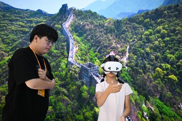 (260912) -- BEIJING, Sept. 12, 2026 (Xinhua) -- A child views the scenery of the Great Wall via a VR device at the themed exhibition area for culture and tourism services during the 2026 China International Fair for Trade in Services (CIFTIS) at Shougang Park in Beijing, capital of China, Sept. 12, 2026. The 2026 CIFTIS, running from Sept. 9 to 13 at Shougang Park in Beijing, has brought together 413 exhibitors at the themed exhibition area for culture and tourism services, showcasing emerging models of cultural and tourism integration. (Xinhua/Zheng Huansong)