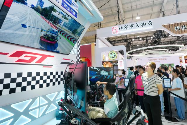 (260912) -- BEIJING, Sept. 12, 2026 (Xinhua) -- A kid experiences simulated racing driving at the themed exhibition area for culture and tourism services during the 2026 China International Fair for Trade in Services (CIFTIS) at Shougang Park in Beijing, capital of China, Sept. 12, 2026. The 2026 CIFTIS, running from Sept. 9 to 13 at Shougang Park in Beijing, has brought together 413 exhibitors at the themed exhibition area for culture and tourism services, showcasing emerging models of cultural and tourism integration. (Xinhua/Ju Huanzong)