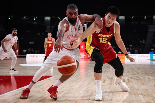 (260912) -- NAGOYA, Sept. 12, 2026 (Xinhua) -- Jiao Boqiao (R) of China vies with Mohamed Juma of Bahrain during the group C match between China and Bahrain at 20th Asian Games Aichi-Nagoya 2026 in Nagoya, Japan, Sept. 12, 2026. (Xinhua/Jia Haocheng)