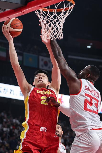 (260912) -- NAGOYA, Sept. 12, 2026 (Xinhua) -- Hu Jinqiu (L) of China vies with Jakarr Sampson of Bahrain during the group C match between China and Bahrain at 20th Asian Games Aichi-Nagoya 2026 in Nagoya, Japan, Sept. 12, 2026. (Xinhua/Jia Haocheng)