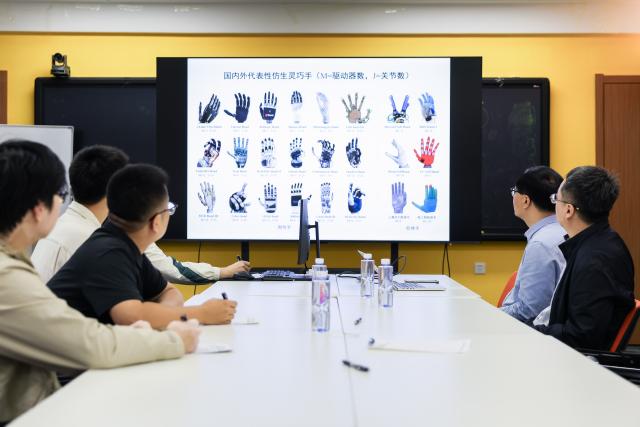 (260912) -- CHANGCHUN, Sept. 12, 2026 (Xinhua) -- Professor Ren Lei (1st R) and team members discuss the development trends of bionic dexterous hands in the world at Jilin University in Changchun, northeast China's Jilin Province, Sept. 7, 2026.
  Currently, the bionic embodied intelligent robot team at Jilin University is conducting frontier research on bionic robots. Bringing together researchers from bionics, mechanics, materials, artificial intelligence, computer science, and information engineering, the team has carried out extensive biomechanical testing and modeling analysis, and pioneered the theory and technology of bionic tension-compression body robots internationally. It has developed bionic tension-compression dexterous hands, robotic arms, and complete robot systems.
   "Drawing wisdom from the human body, we are using bionic tension-compression body technology to rebuild the industrial backbone of China's robotics industry, in hopes of truly equipping our robots with human-like dexterity and intelligence," said Ren Lei, academic leader of bionic robotics at Jilin University. (Xinhua/Xu Chang)