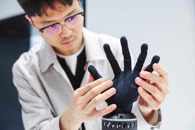 (260912) -- CHANGCHUN, Sept. 12, 2026 (Xinhua) -- A member of a bionic embodied intelligent robot team adjusts a bionic tension-compression dexterous hand at a bionic robot innovation center in Changchun, northeast China's Jilin Province, Sept. 7, 2026.
  Currently, the bionic embodied intelligent robot team at Jilin University is conducting frontier research on bionic robots. Bringing together researchers from bionics, mechanics, materials, artificial intelligence, computer science, and information engineering, the team has carried out extensive biomechanical testing and modeling analysis, and pioneered the theory and technology of bionic tension-compression body robots internationally. It has developed bionic tension-compression dexterous hands, robotic arms, and complete robot systems.
   "Drawing wisdom from the human body, we are using bionic tension-compression body technology to rebuild the industrial backbone of China's robotics industry, in hopes of truly equipping our robots with human-like dexterity and intelligence," said Ren Lei, academic leader of bionic robotics at Jilin University. (Xinhua/Xu Chang)