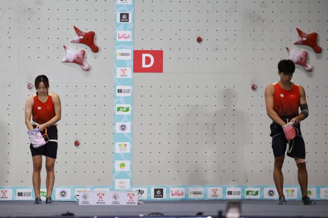 (260912) -- GUIYANG, Sept. 12, 2026 (Xinhua) -- Zhou Ziyu (R) and Zhang Mengli of China react before the mixed speed relay at the World Climbing Series Guiyang 2026 in Guiyang, southwest China's Guizhou Province, Sept. 12, 2026. (Xinhua/Liu Xu)