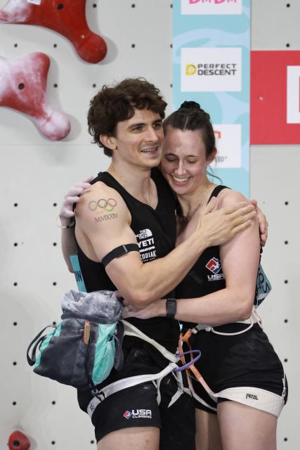 (260912) -- GUIYANG, Sept. 12, 2026 (Xinhua) -- Samuel Watson (L) of the United States hugs his partner Emma Hunt after the mixed speed relay at the World Climbing Series Guiyang 2026 in Guiyang, southwest China's Guizhou Province, Sept. 12, 2026. (Xinhua/Liu Xu)