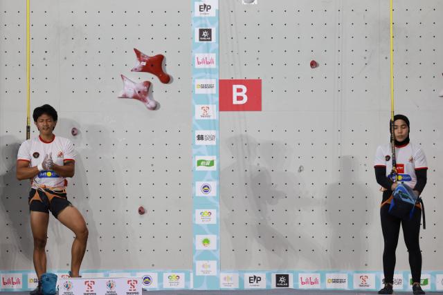 (260912) -- GUIYANG, Sept. 12, 2026 (Xinhua) -- Raharjati Nursamsa (L) and Rajiah Sallsabillah of Indonesia react before the mixed speed relay at the World Climbing Series Guiyang 2026 in Guiyang, southwest China's Guizhou Province, Sept. 12, 2026. (Xinhua/Liu Xu)