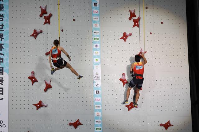 (260912) -- GUIYANG, Sept. 12, 2026 (Xinhua) -- Zhou Ziyu (R) and Zhang Mengli of China compete during the mixed speed relay at the World Climbing Series Guiyang 2026 in Guiyang, southwest China's Guizhou Province, Sept. 12, 2026. (Xinhua/Liu Xu)