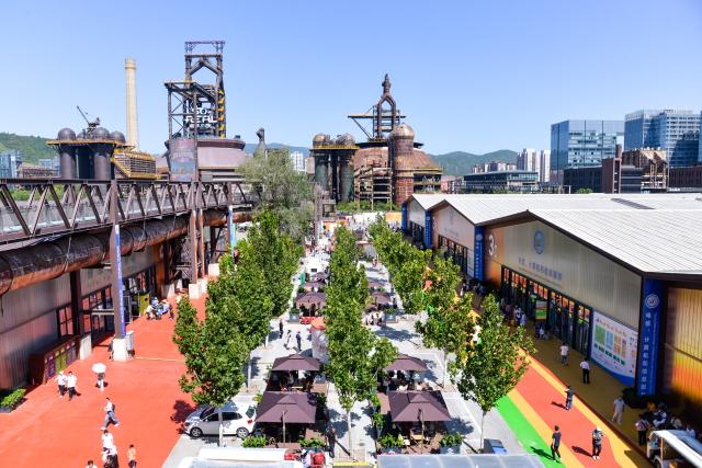 (260912) -- BEIJING, Sept. 12, 2026 (Xinhua) -- People visit the 2025 China International Fair for Trade in Services at Shougang Park in Beijing, capital of China, Sept. 14, 2025.
  Beijing's Shougang Park saw its last blast furnace shut down in 2010, marking the end of more than a century of steelmaking. After more than a decade of transformation, the former industrial site now blends preserved steel structures with modern architecture and green spaces.
  The park hosted the Big Air Shougang, a landmark venue of the Beijing 2022 Winter Olympics, and has since evolved into a hub for exhibitions, commerce, sports and cultural tourism. It is now the permanent venue of the China International Fair for Trade in Services and has also attracted businesses in emerging fields such as science fiction and technology.
  From an old industrial site to a vibrant urban destination, Shougang Park offers a vivid example of how China is transforming its traditional industrial bases. (Xinhua/Xu Qin)