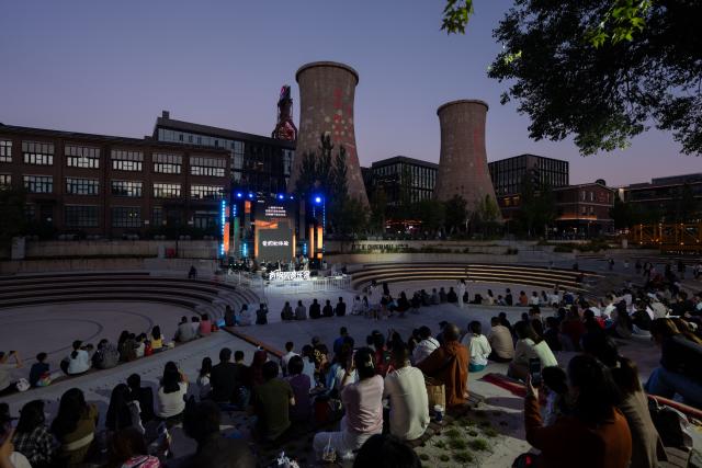 (260912) -- BEIJING, Sept. 12, 2026 (Xinhua) -- People enjoy a concert at Shougang Park in Beijing, capital of China, Sept. 11, 2026.
  Beijing's Shougang Park saw its last blast furnace shut down in 2010, marking the end of more than a century of steelmaking. After more than a decade of transformation, the former industrial site now blends preserved steel structures with modern architecture and green spaces.
  The park hosted the Big Air Shougang, a landmark venue of the Beijing 2022 Winter Olympics, and has since evolved into a hub for exhibitions, commerce, sports and cultural tourism. It is now the permanent venue of the China International Fair for Trade in Services and has also attracted businesses in emerging fields such as science fiction and technology.
  From an old industrial site to a vibrant urban destination, Shougang Park offers a vivid example of how China is transforming its traditional industrial bases. (Xinhua/Zhang Xiaoyu)