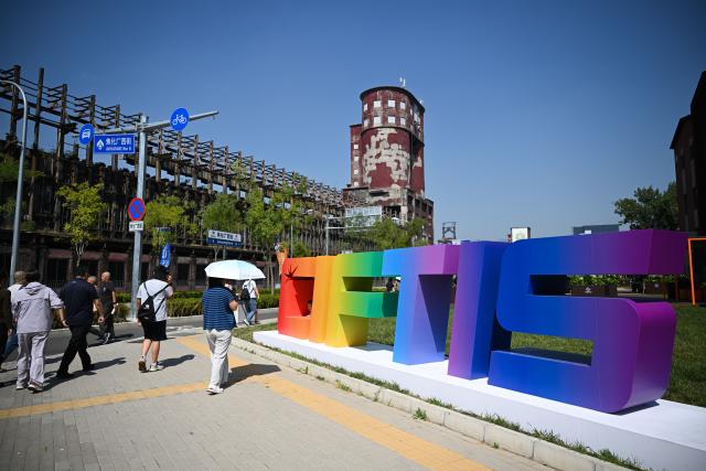(260912) -- BEIJING, Sept. 12, 2026 (Xinhua) -- People visit the 2026 China International Fair for Trade in Services at Shougang Park in Beijing, capital of China, Sept. 12, 2026.
  Beijing's Shougang Park saw its last blast furnace shut down in 2010, marking the end of more than a century of steelmaking. After more than a decade of transformation, the former industrial site now blends preserved steel structures with modern architecture and green spaces.
  The park hosted the Big Air Shougang, a landmark venue of the Beijing 2022 Winter Olympics, and has since evolved into a hub for exhibitions, commerce, sports and cultural tourism. It is now the permanent venue of the China International Fair for Trade in Services and has also attracted businesses in emerging fields such as science fiction and technology.
  From an old industrial site to a vibrant urban destination, Shougang Park offers a vivid example of how China is transforming its traditional industrial bases. (Xinhua/Zheng Huansong)