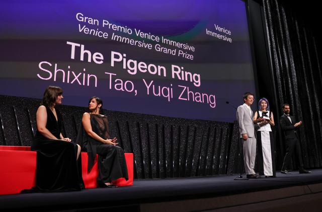 (260912) -- VENICE, Sept. 12, 2026 (Xinhua) -- Director Zhang Yuqi (2nd R) and director Tao Shixin (3rd R) of the short film "The Pigeon Ring" attend the awarding ceremony of the 83rd Venice International Film Festival in Venice, Italy, Sept. 12, 2026. Chinese short film The Pigeon Ring won the Venice Immersive Grand Prize, the top award of the Venice Immersive section, at the 83rd Venice International Film Festival on Saturday. (Xinhua/Wang Kaiyan)