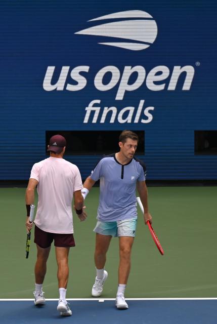 (260913) -- NEW YORK, Sept. 13, 2026 (Xinhua) -- Christian Harrison (L)/Neal Skupski celebrate scoring during the men's doubles final match between Christian Harrison (the United States)/Neal Skupski (Britain) and Kevin Krawietz/Tim Puetz of Germany at the 2026 US Open tennis championships in New York, the United States, Sept. 12, 2026. (Xinhua/Li Rui)