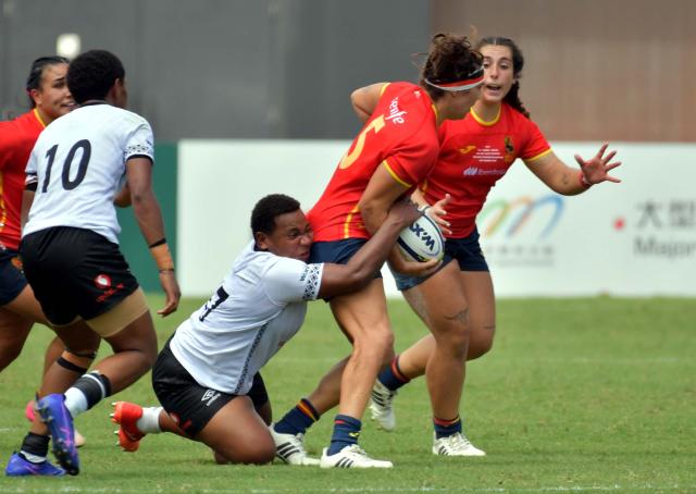 (260913) -- HONG KONG, Sept. 13, 2026 (Xinhua) -- Zipporah Sorokacika (down) of Fiji defends Lourdes Alameda (2nd R) of Spain during the pool match between Spain and Fiji of WXV Global Series rugby competition in Hong Kong, south China, Sept. 13, 2026. (Xinhua/Lo Ping Fai)