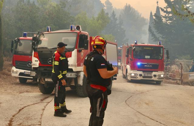 (260913) -- ZAGREB, Sept. 13, 2026 (Xinhua) -- Members of the Croatian firefighting service work at the site of a wildfire near the town of Milna on the island of Brac, Croatia, on Sept. 12, 2026. A large wildfire burning on the Croatian island of Brac for days has spread toward villages and tourist facilities overnight, prompting the evacuation of more than 200 people, local media reported Sunday. (Ivo Cagalj/PIXSELL via Xinhua)
