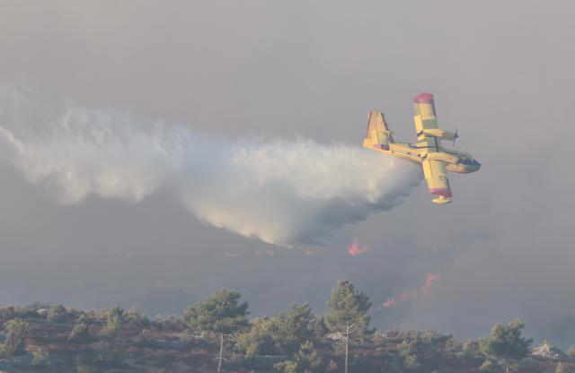 (260913) -- ZAGREB, Sept. 13, 2026 (Xinhua) -- A firefighting plane drops water on a wildfire near the town of Milna on the island of Brac, Croatia, on Sept. 12, 2026. A large wildfire burning on the Croatian island of Brac for days has spread toward villages and tourist facilities overnight, prompting the evacuation of more than 200 people, local media reported Sunday. (Ivo Cagalj/PIXSELL via Xinhua)