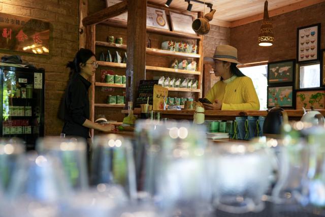 (260914) -- LINCANG, Sept. 14, 2026 (Xinhua) -- A tourist (R) enjoys coffee at Xigui coffee estate in Xigui Village of Lincang City, southwest China's Yunnan Province on Sept. 13, 2026. As one of the important coffee production areas in Yunnan Province, Lincang City, relying on its unique natural resources, has vigorously developed a business model integrating coffee industry and tourism. Tourists can experience coffee culture in an immersive way at the coffee estates, unlocking new experiences of rural leisure.
   By the end of 2025, the coffee planting area in Lincang City had reached approximately 290,000 mu (about 19,333 hectares). The coffee industry is becoming an important engine driving the development of local agricultural, cultural and tourism economy. (Xinhua/Chen Xinbo)