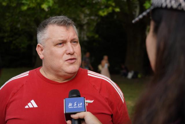 (260914) -- BUDAPEST, Sept. 14, 2026 (Xinhua) -- Istvan Vargo, president of both the Hungarian Wushu Association and the Hungarian Chan Wu Federation, receives an interview during the 6th Family and Friends Gathering of the Hungarian Chan Wu Federation on Margaret Island in Budapest, Hungary, Sept. 13, 2026. (Xinhua/Chen Hao)