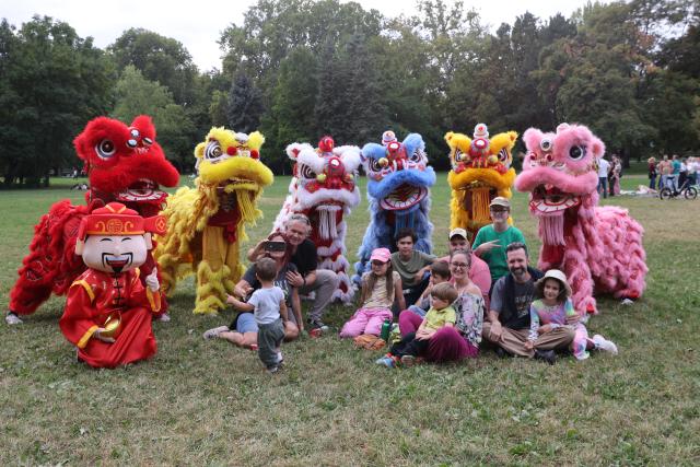 (260914) -- BUDAPEST, Sept. 14, 2026 (Xinhua) -- People pose for a photo with lion dancers during the 6th Family and Friends Gathering of the Hungarian Chan Wu Federation on Margaret Island in Budapest, Hungary, Sept. 13, 2026. (Photo by Attila Volgyi/Xinhua)