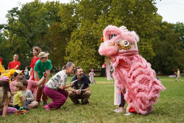 (260914) -- BUDAPEST, Sept. 14, 2026 (Xinhua) -- People interact with lion dancers during the 6th Family and Friends Gathering of the Hungarian Chan Wu Federation on Margaret Island in Budapest, Hungary, Sept. 13, 2026. (Xinhua/Chen Hao)